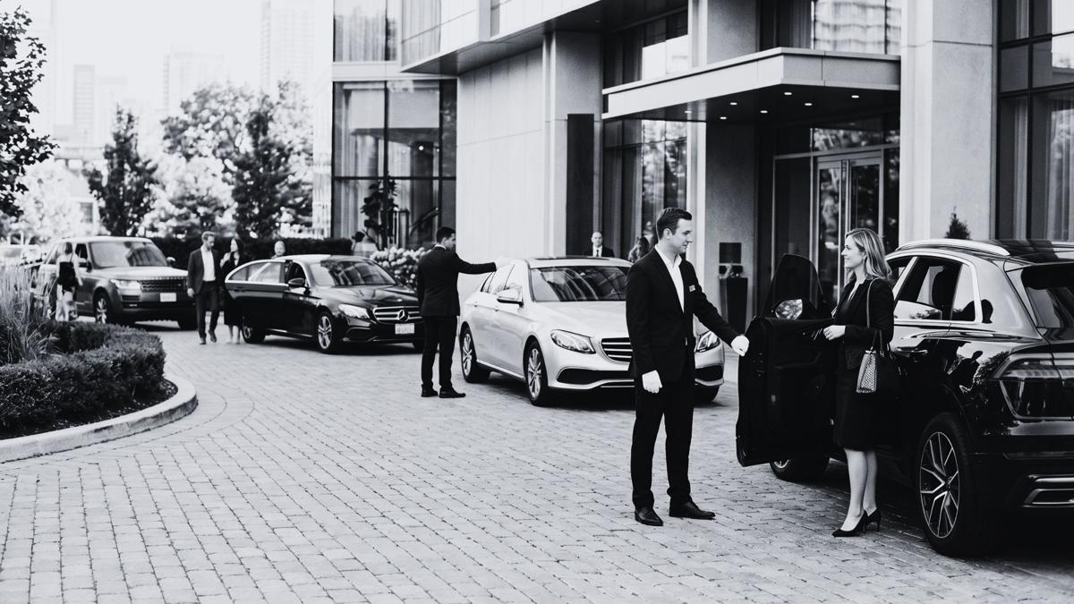 Professional valet attendants assisting guests with vehicle arrivals outside a luxury hotel in Toronto, demonstrating organized event valet parking and premium guest hospitality.